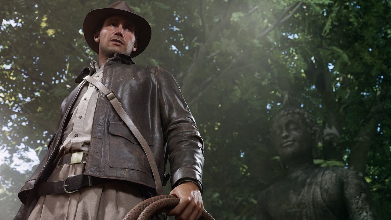 Indy stands in a jungle with his whip